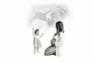 Black and white maternity photo of pregnant woman kneeling beside toddler girl, with soft ultrasound image overlay.