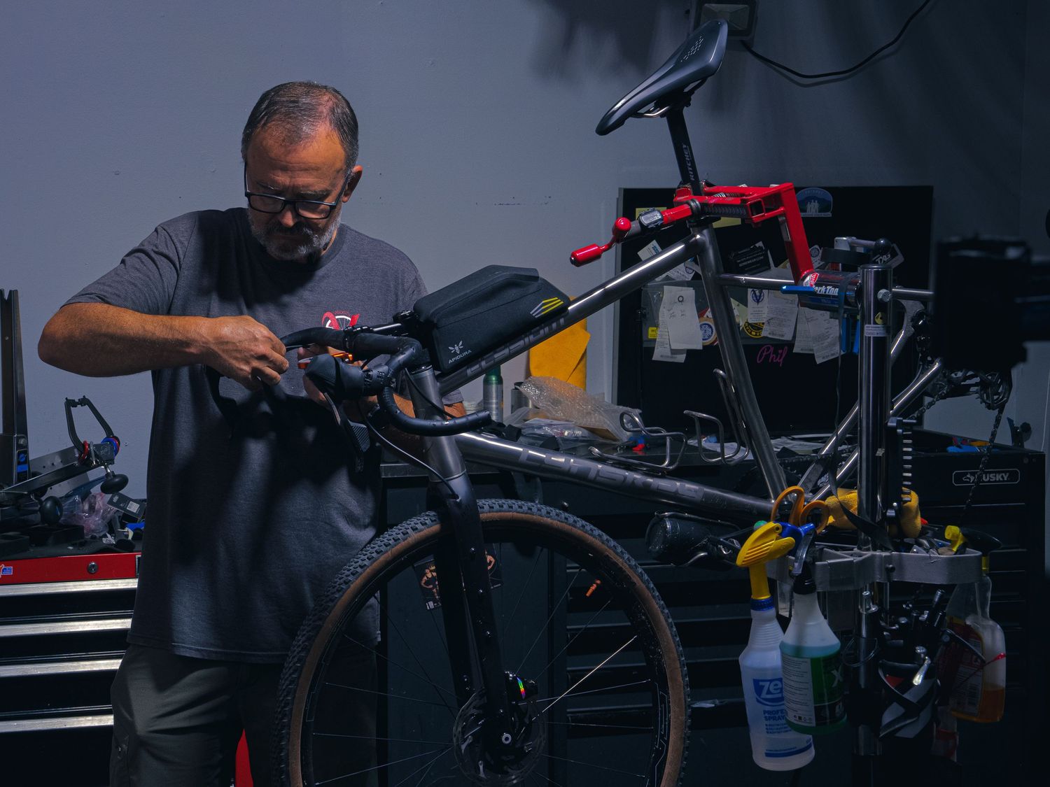 The owner of Velocity Multi Sport & Cycling working on a mountain bike at the repair stand in his Janesville, WI shop.