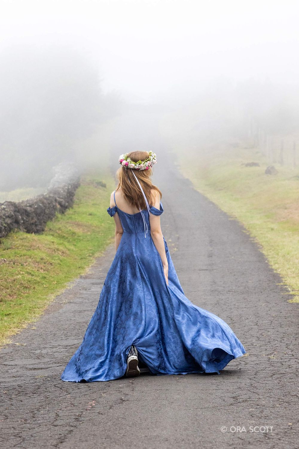 High school senior portraits on Thompson Road in upcountry Maui with senior wearing blue dress and head lei flower crown