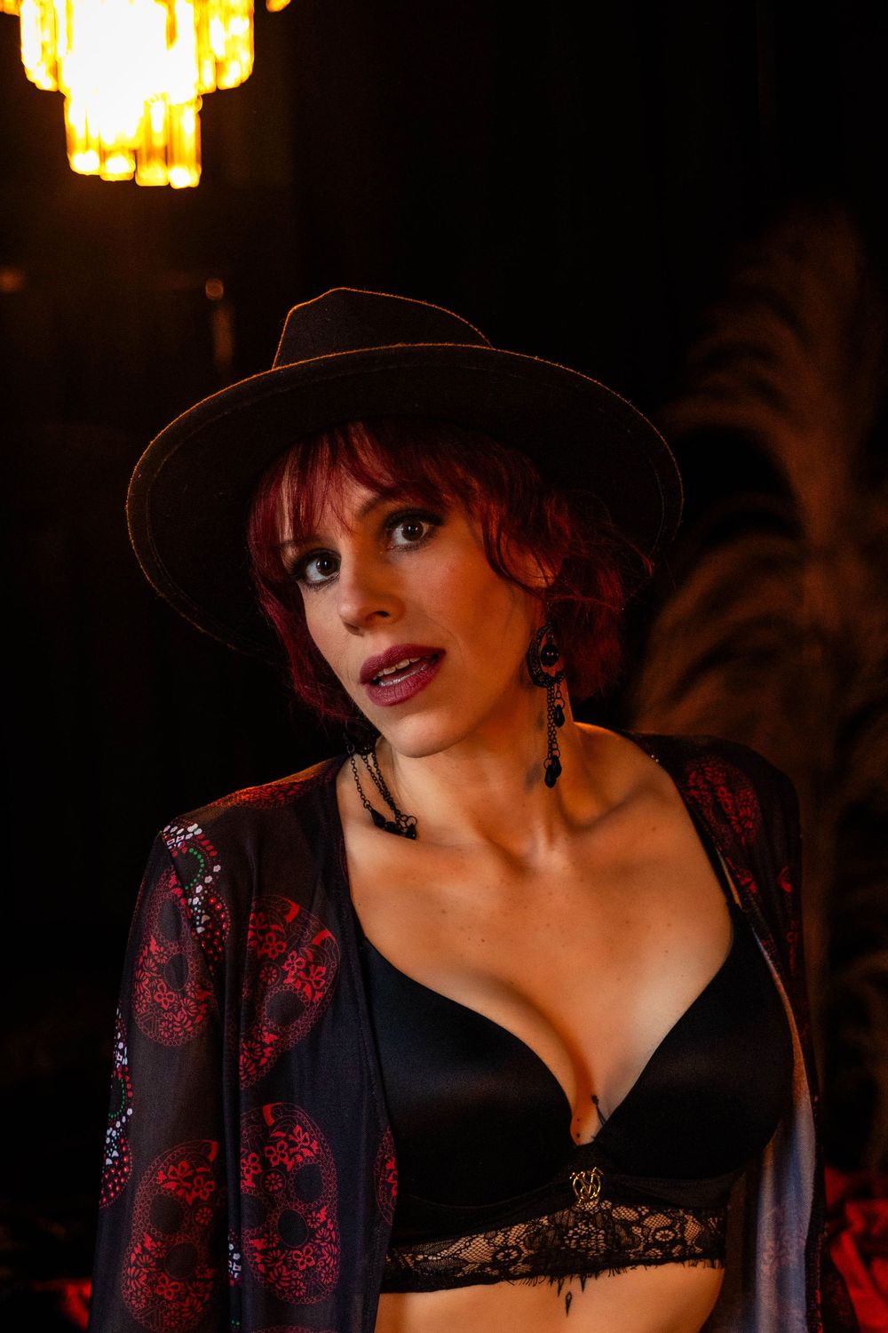 A woman in a black hat poses for the camera.