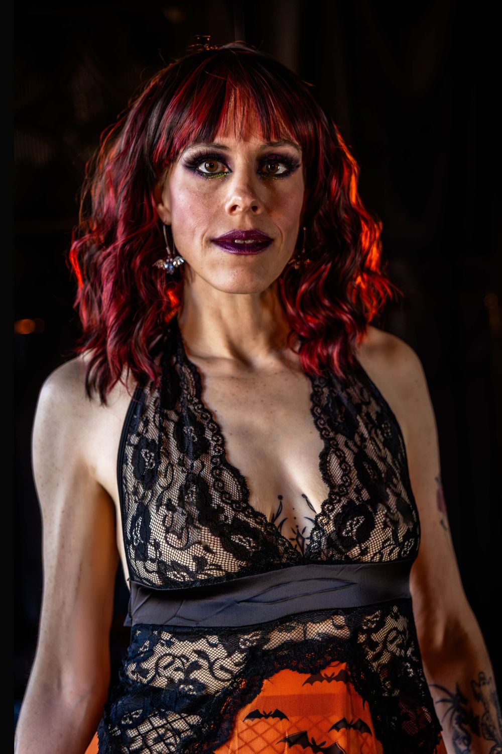 A woman with red hair poses for the camera.
