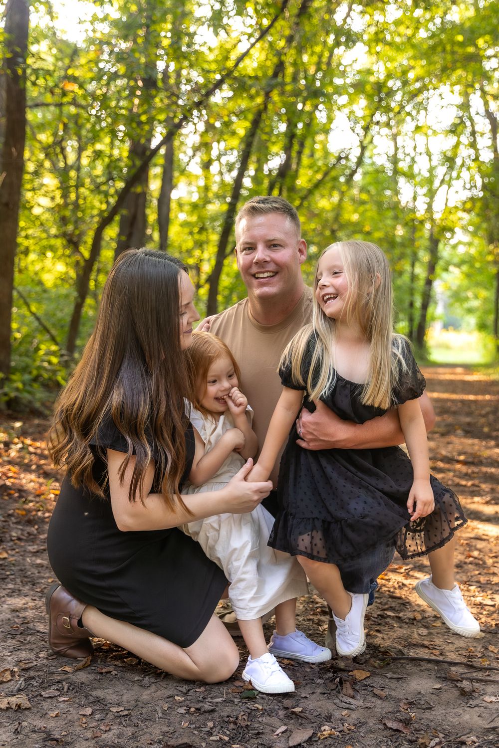 Happy family sharing joyful moment together on wooded trail.