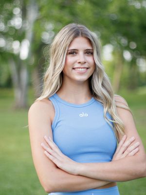 Person in light blue athletic tank top shown in multiple outdoor poses against blurred green background.