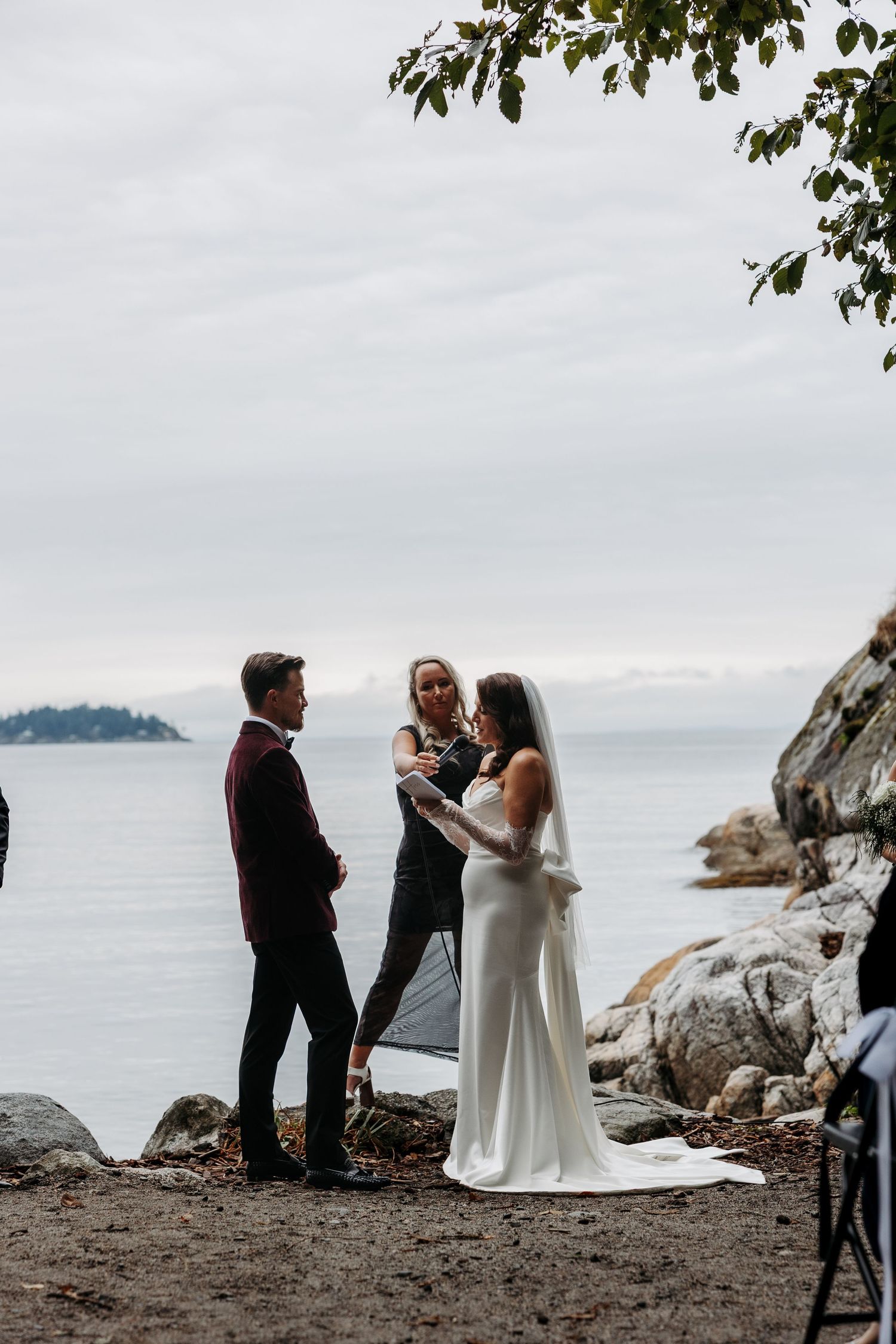 Three intimate wedding photos showing a couple on a rocky beach with mountains and ocean in the background.