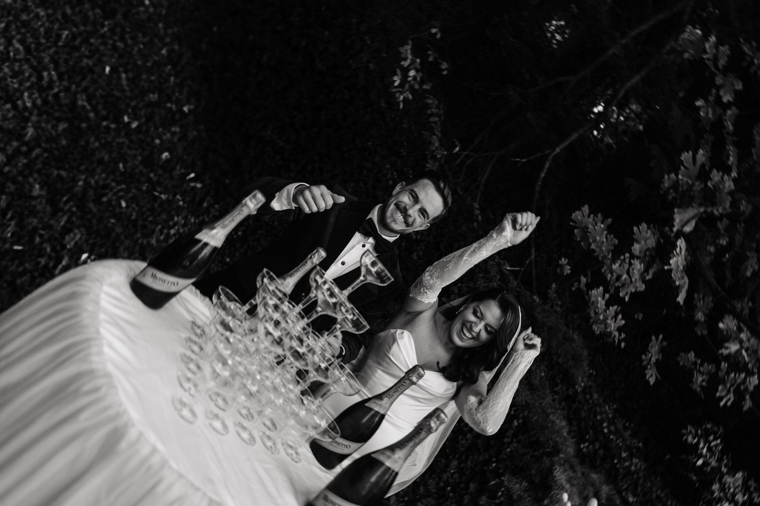 A black and white photo series shows a couple in formal attire dancing together in a romantic setting.