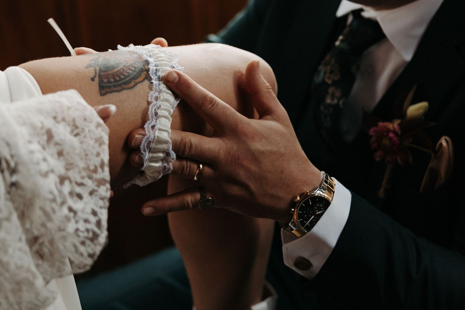 Close-up of hands exchanging wedding rings during an elegant ceremony.
