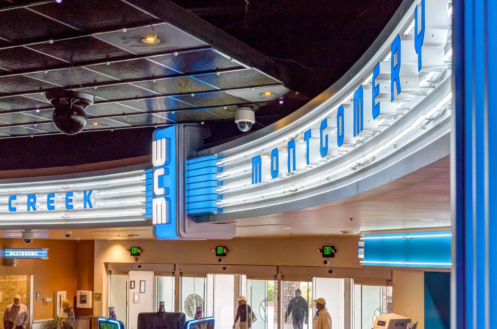Art deco style theater entrance with blue neon lighting and curved architectural details.