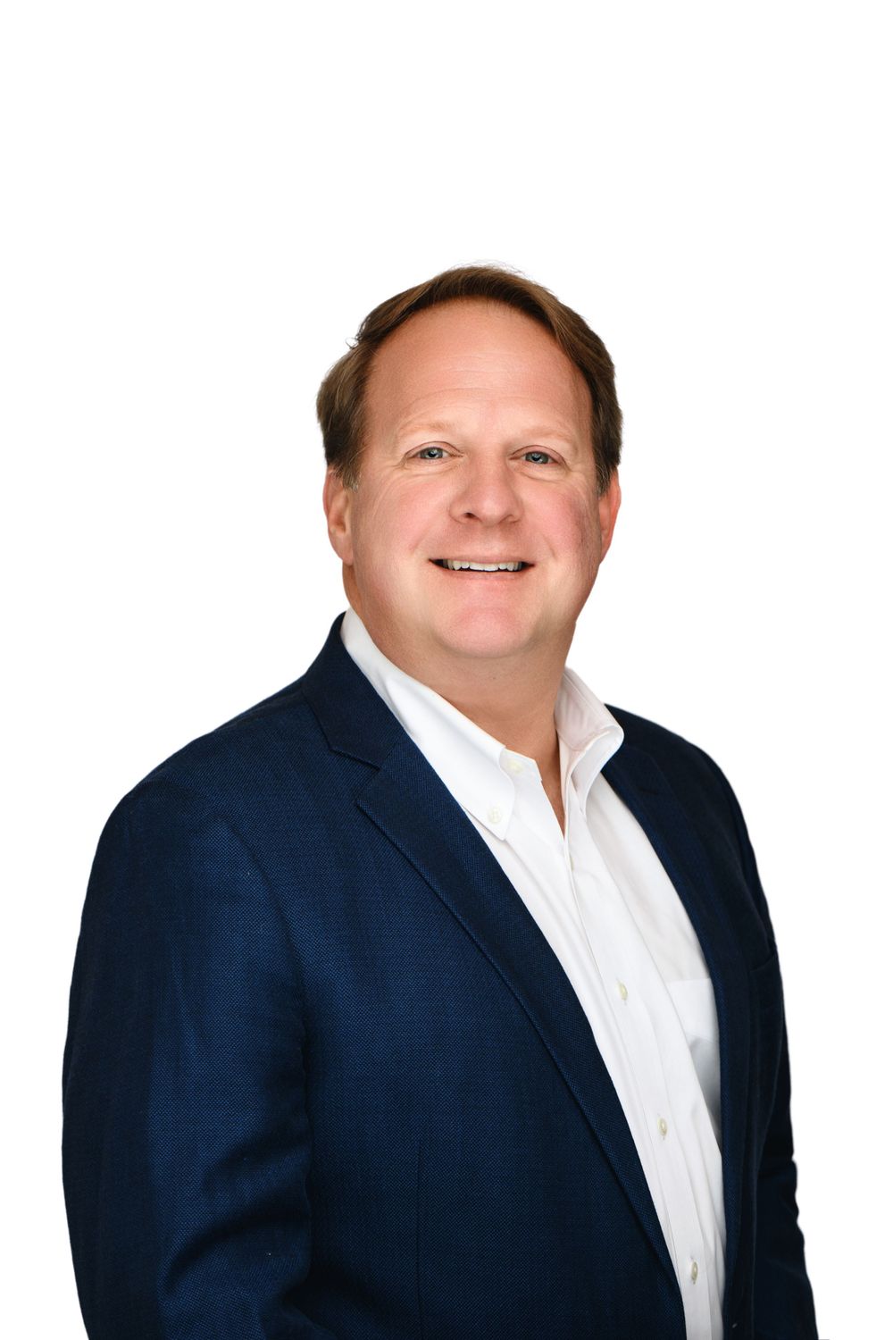Professional business portrait of person in navy suit and white shirt against white background.