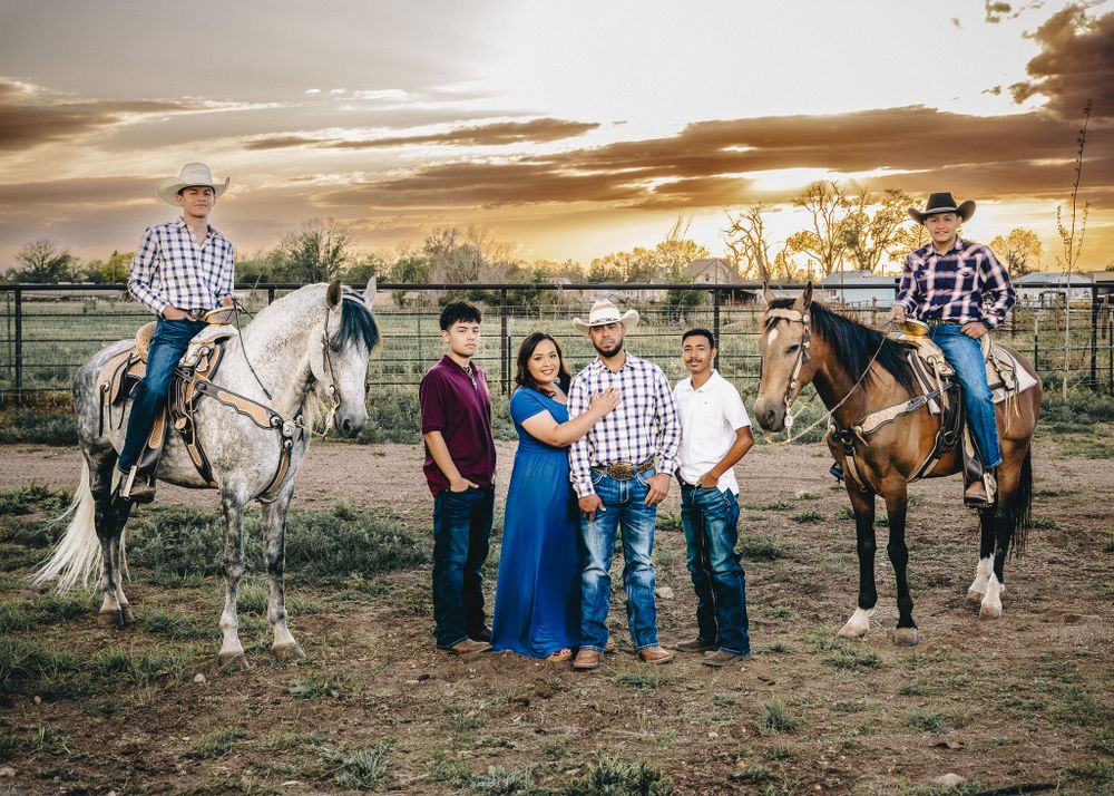 sunset family session at ranch with horses in colorado. family of 6 posing in the mountains.liz rivas illuminating images.