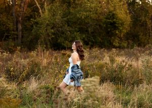 Running through a field of tall grass at golden hour.