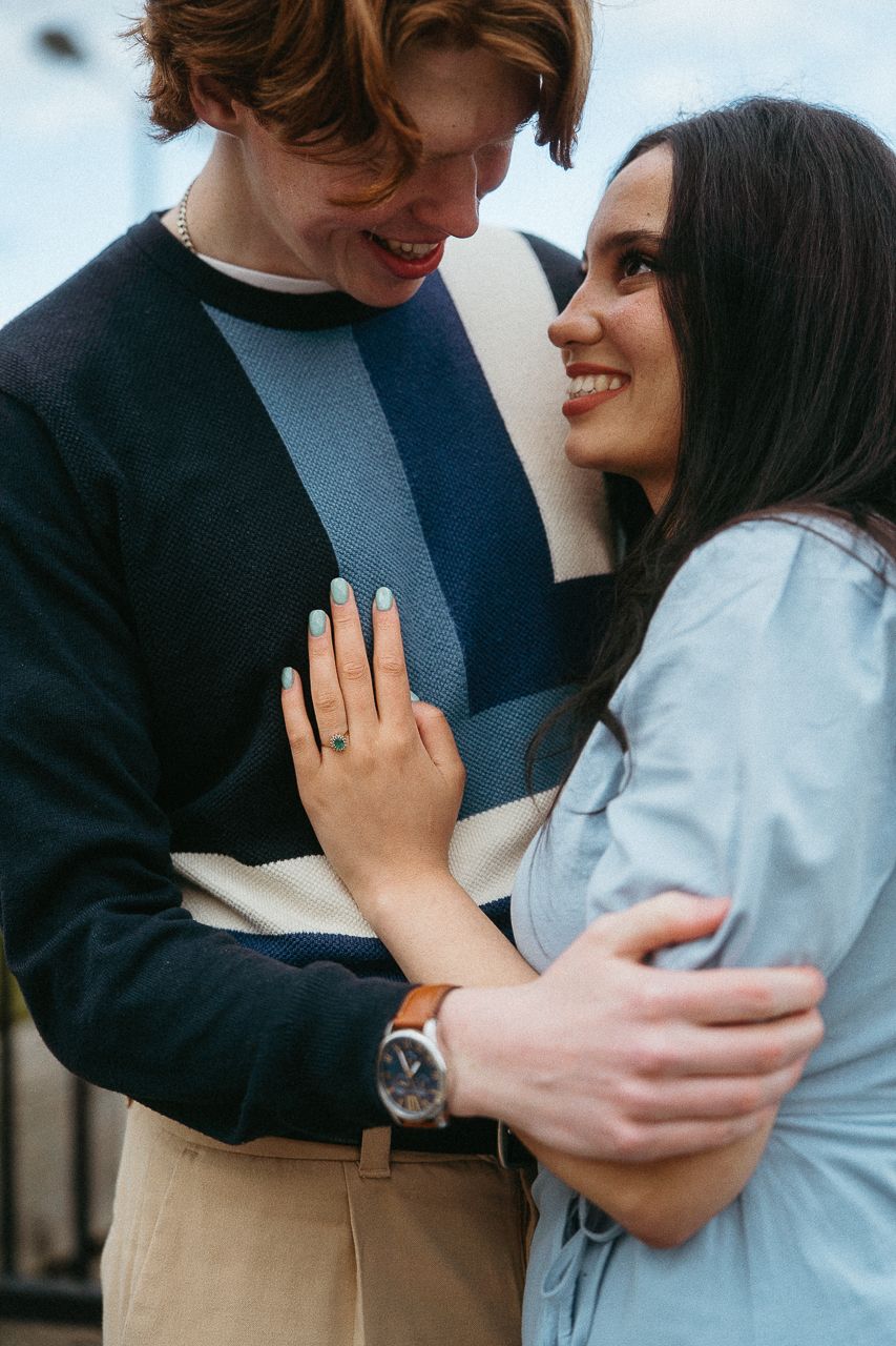 Close-up shots of couple embracing showing engagement ring and intimate moments.