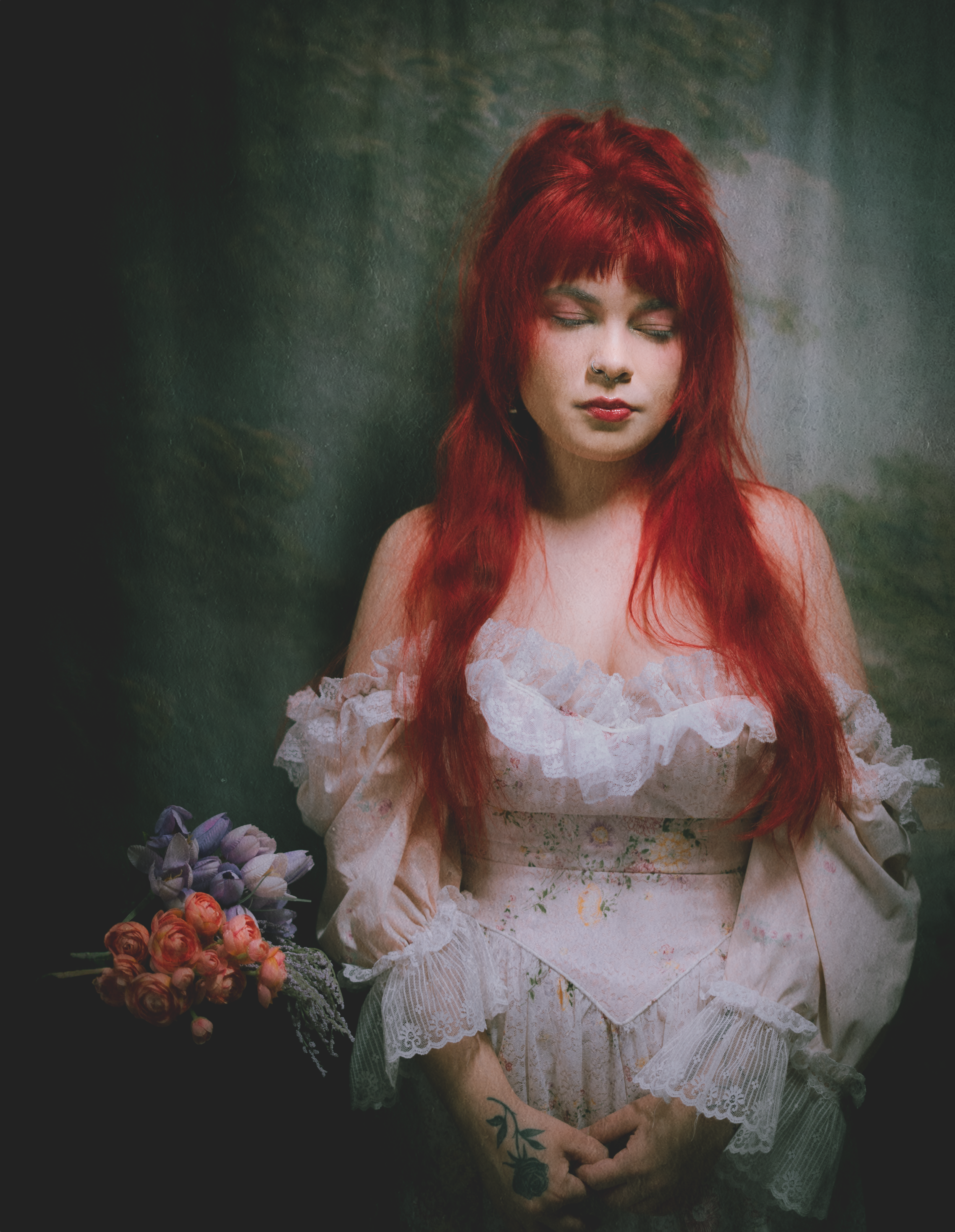 Ethereal portrait featuring white lace dress and floral elements in dark setting.