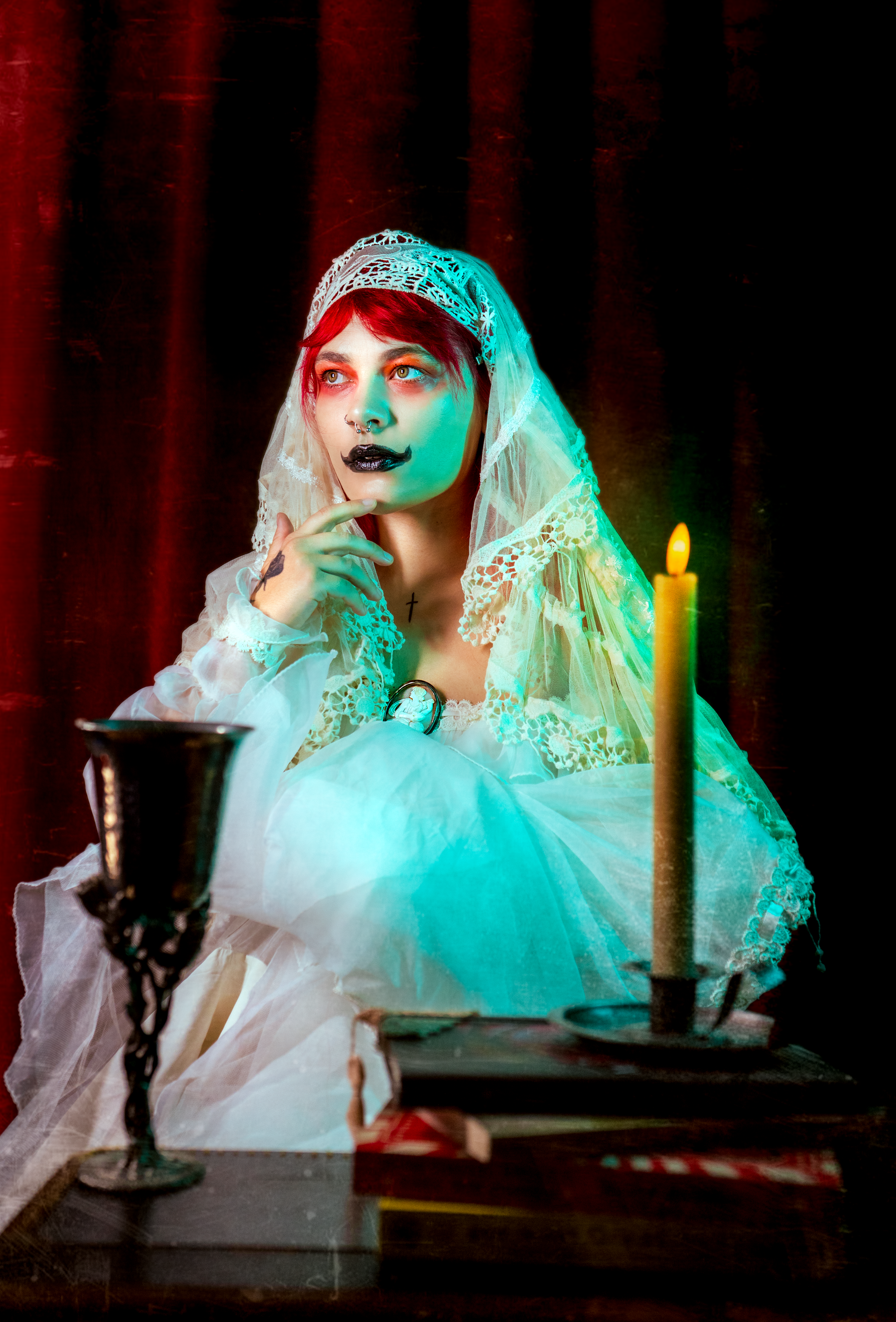Ethereal scene with turquoise lighting and white lace veil creating a ghostly atmosphere.