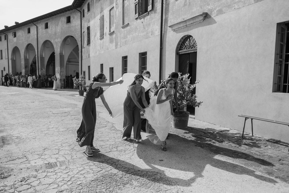 People dancing in a courtyard of an old Italian building.