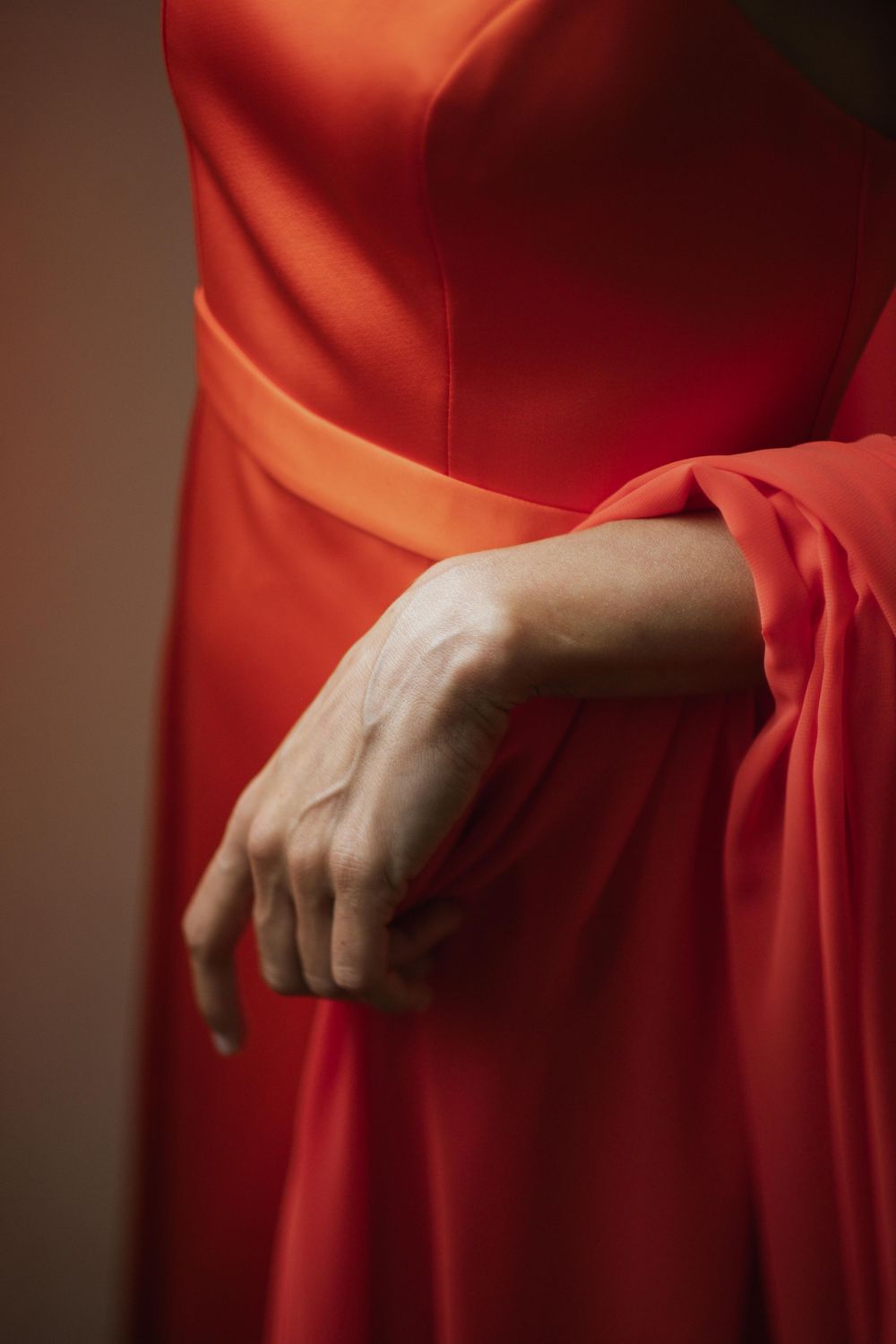 Detail shot of flowing red fabric from a formal dress.