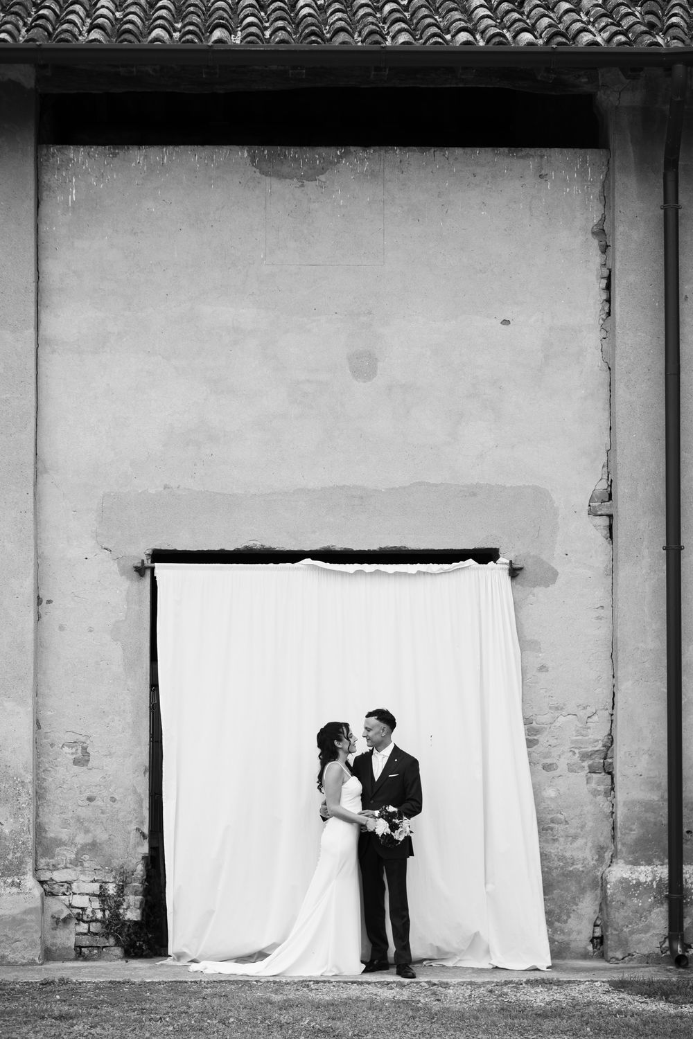 Black and white architectural series with white backdrop against textured wall.