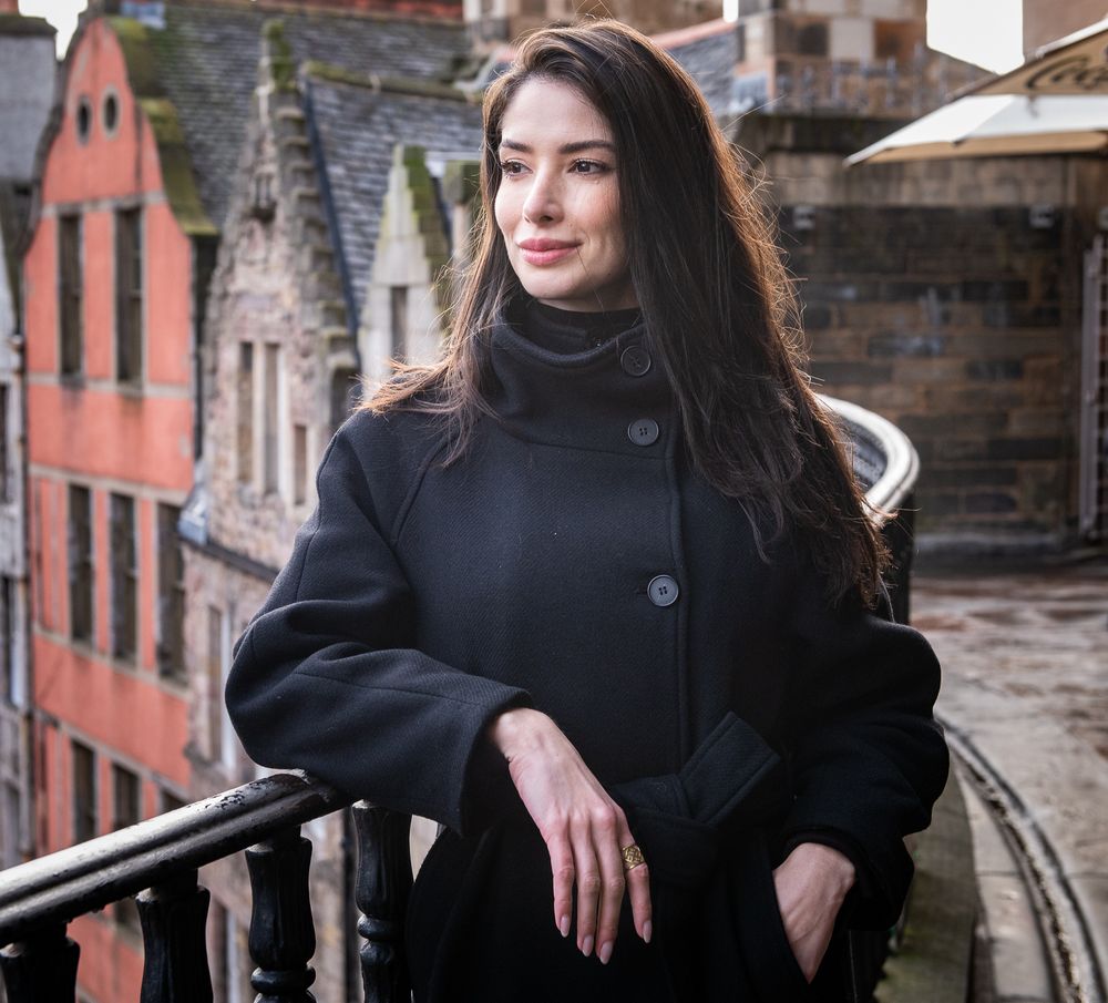 Image of tourist from Brazil on the Wee Scotia Tour on Victoria Street Balcony, Edinburgh