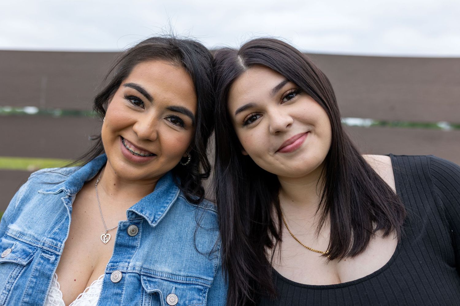 mother and daughter leaning on eachother