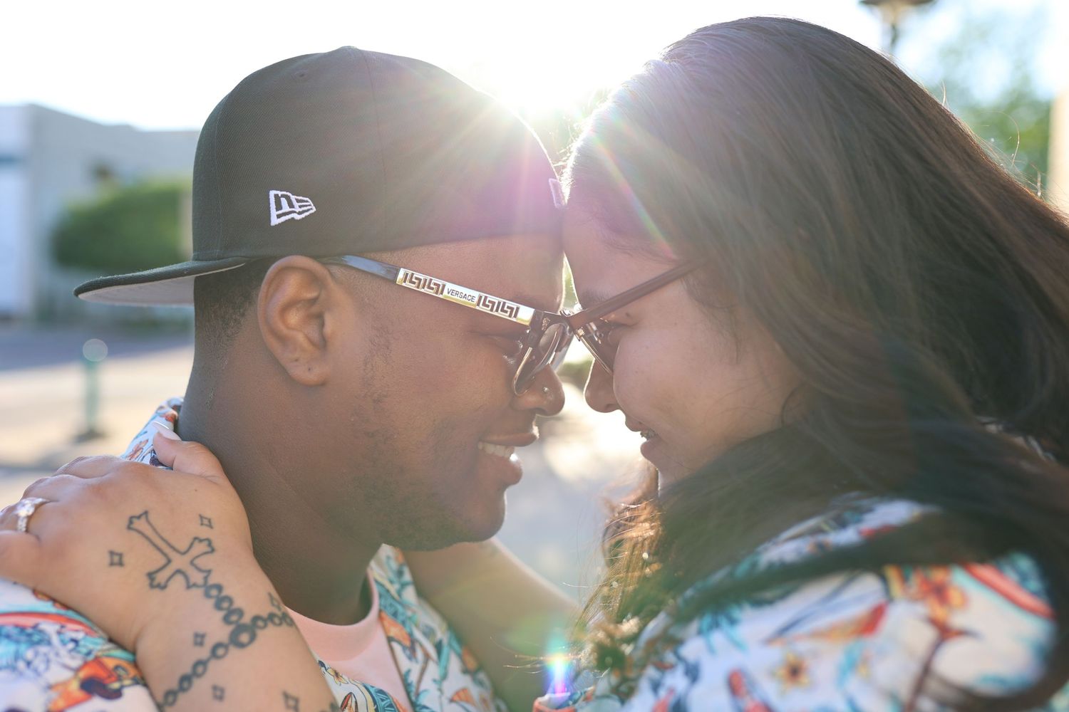 couple looking in each others eyes with sun in between them
