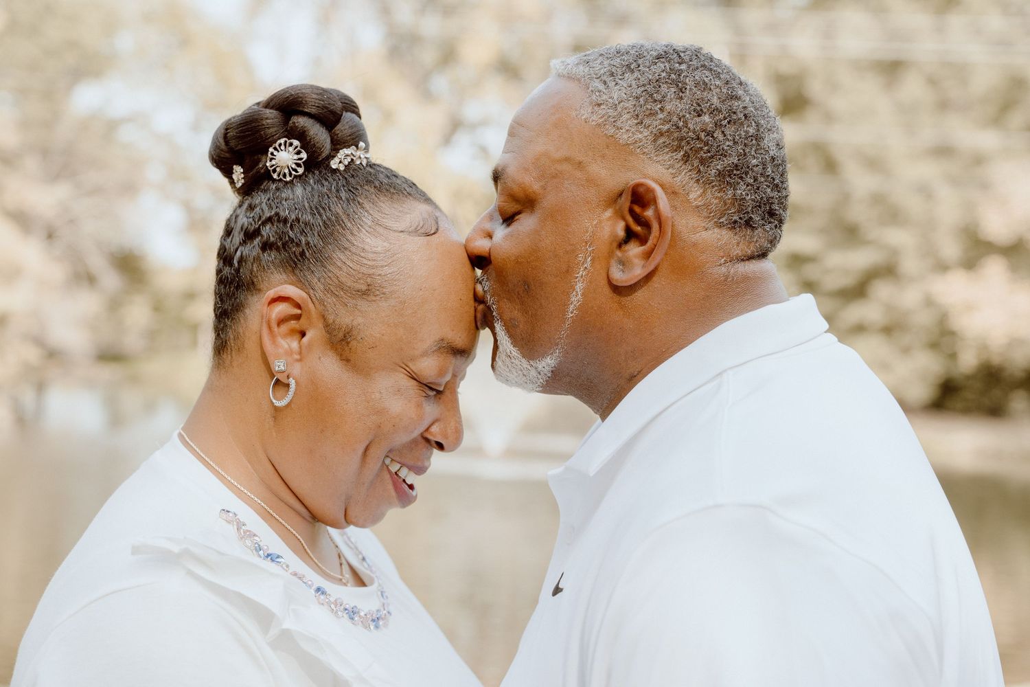 husband kissing wife on forehead