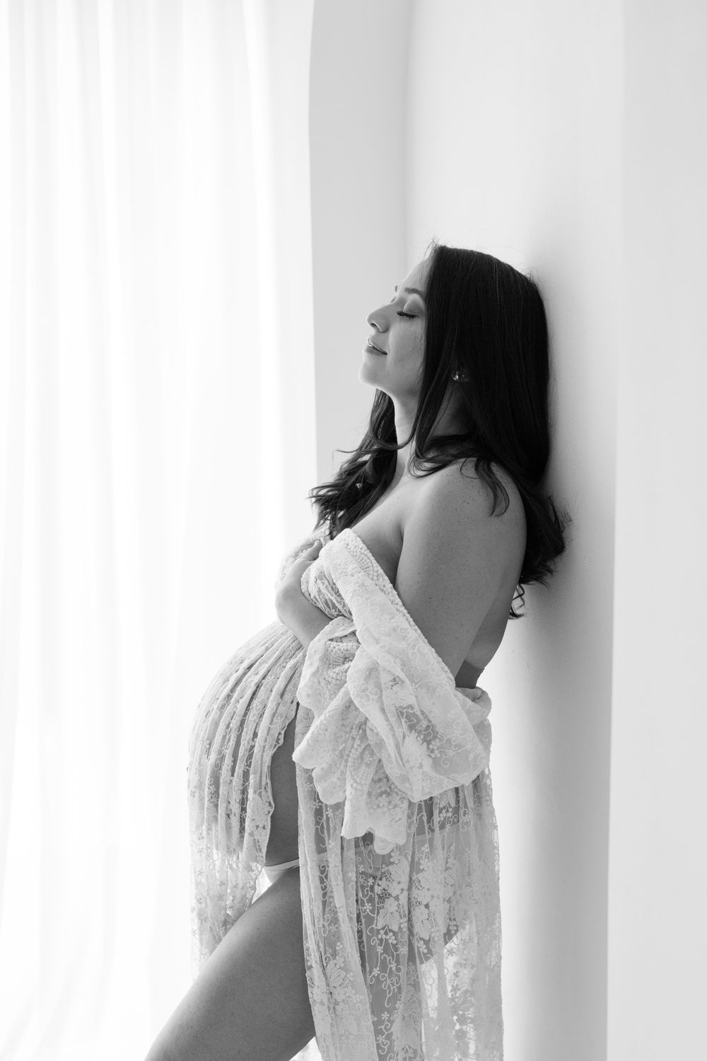 A series of black and white artistic portraits showing a person in a white lace top against a light background.