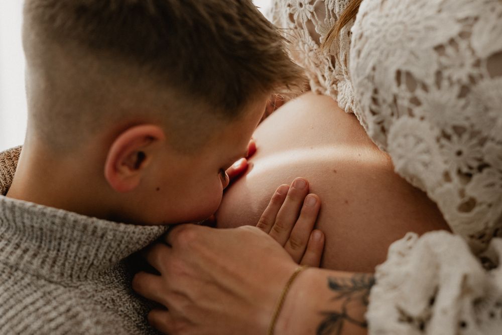 Intimate close-up photograph of skin texture and shadows in warm sepia tones.