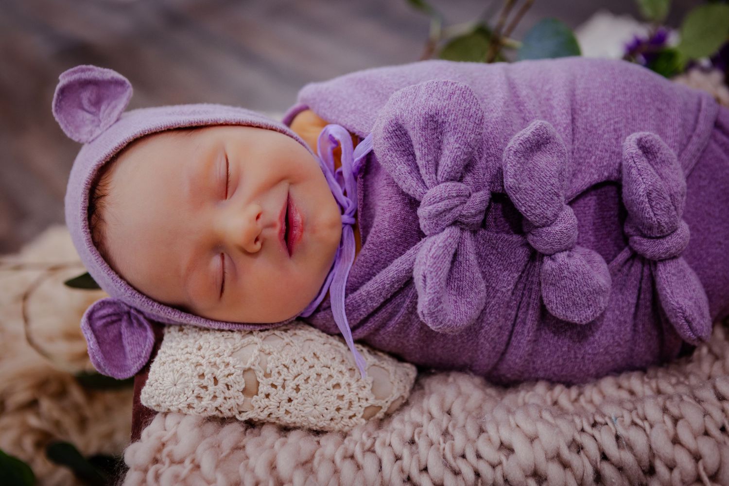 smiling baby wrapped in swaddles