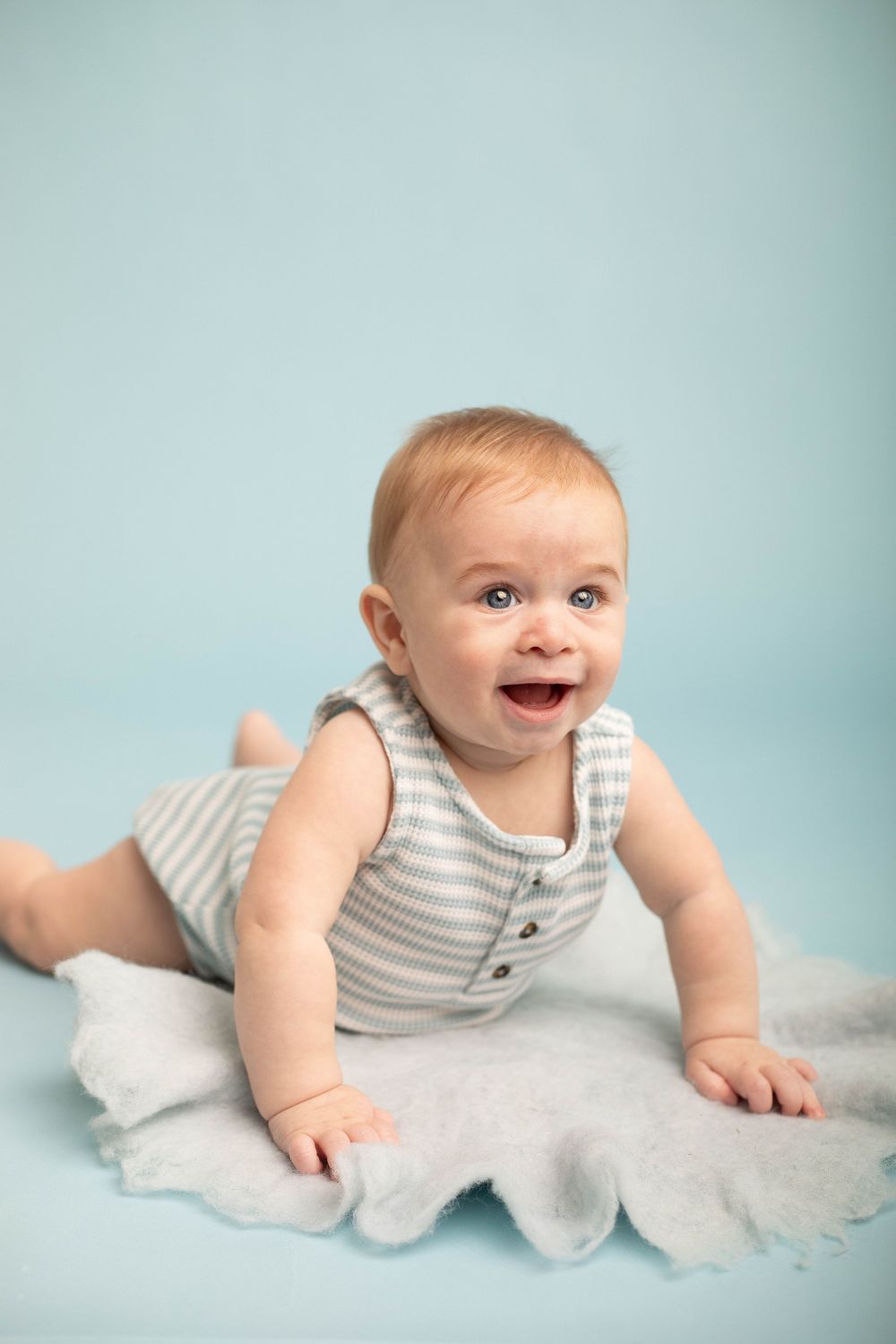 Smiling baby photographed during a milestone session in Central Louisiana.