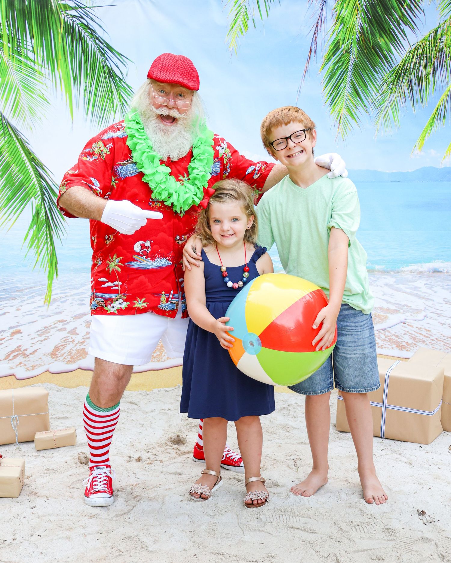A cheerful summer-themed holiday photo with beach ball and tropical decorations.