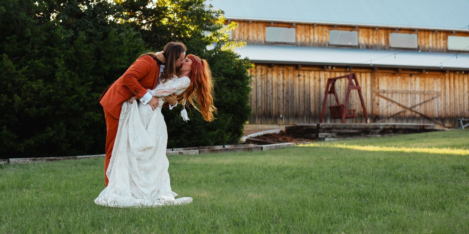 Romantic sunset photo of couple embracing in front of rustic barn. Denison North Texas Wedding Photography
