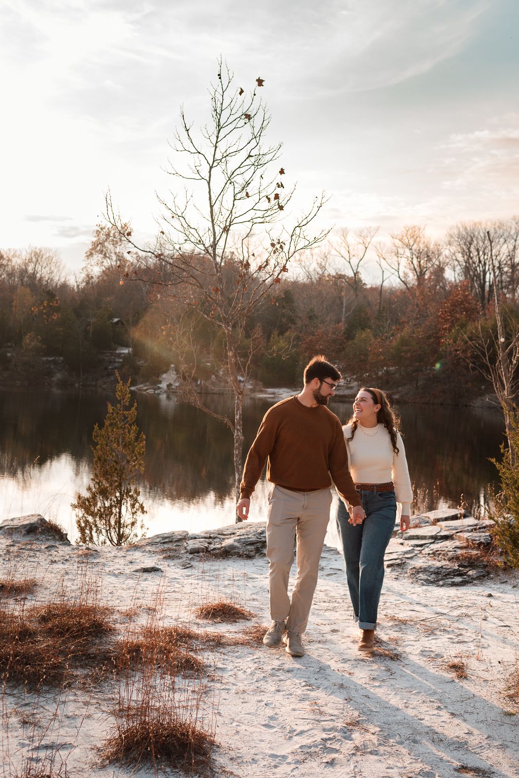 Series of winter engagement photos showing couple walking along snowy lakeshore at sunset.