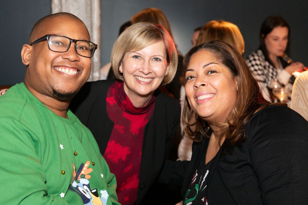 group of 3 people at an event