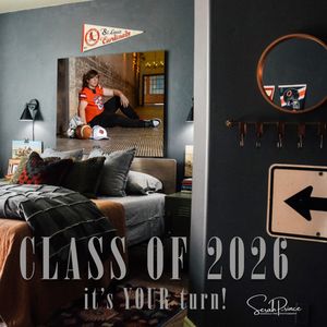 Dark classroom interior with 'Class of 2026' text displayed on wall and dramatic lighting.