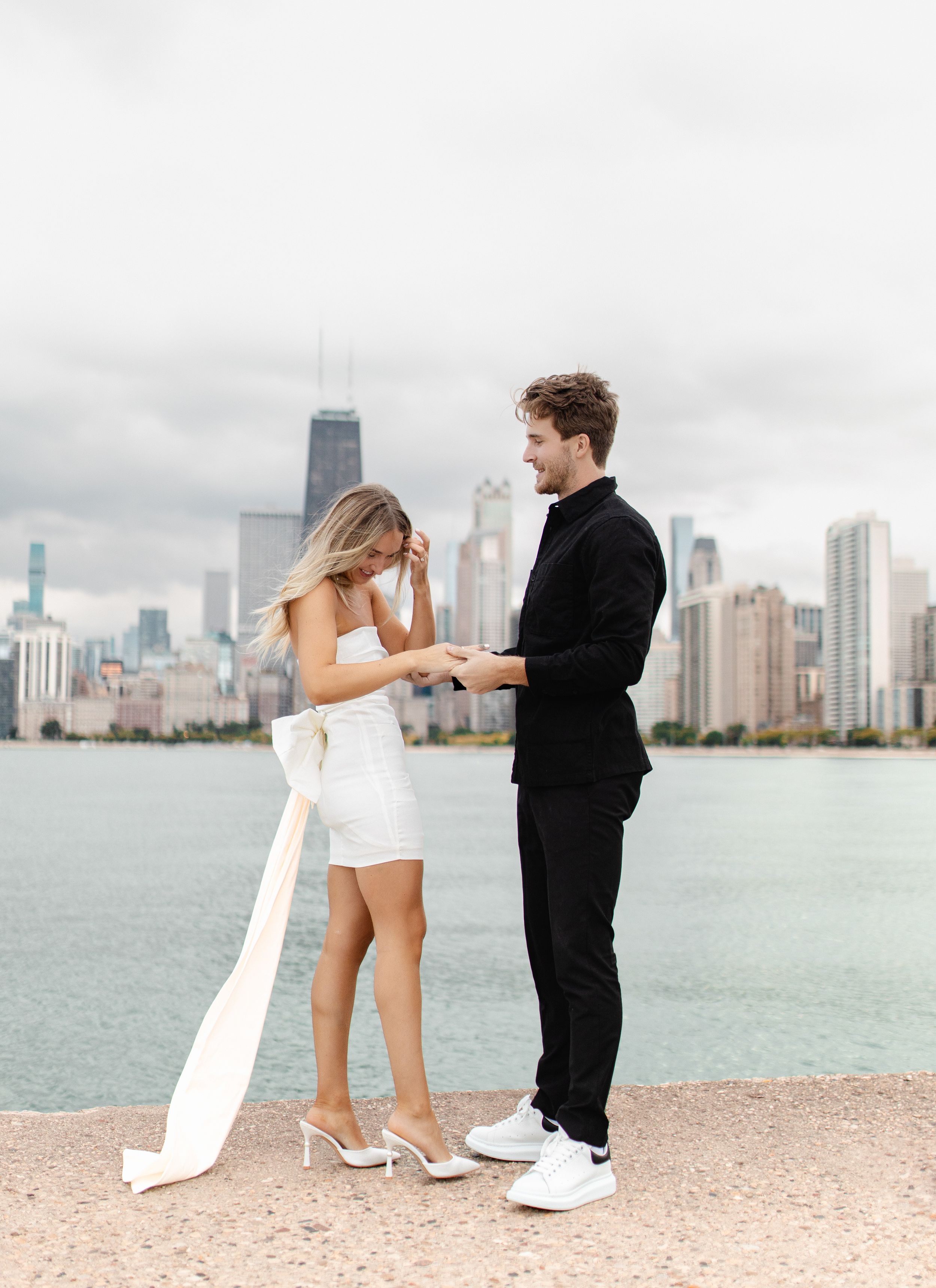 Romantic moment captured between couple against Chicago's lakefront skyline.