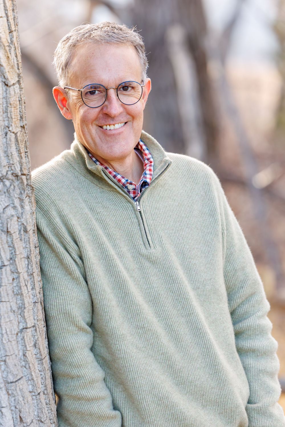 A collage of outdoor portraits showing someone wearing glasses and a mint green sweater against a natural backdrop.