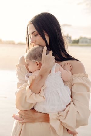 Intimate family portraits in soft beige tones against a light background.