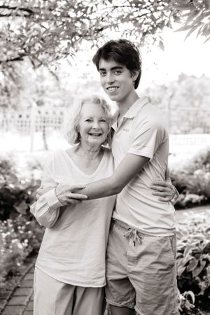 Black and white portraits capturing tender embraces in a garden setting.