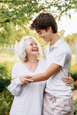 Candid moments of laughter and hugs shared in a sunlit garden.