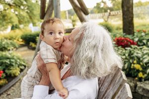 Candid outdoor family photos showing loving interactions in a garden setting.