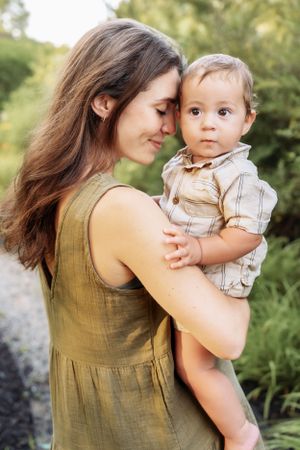 Intimate family portraits showing tender moments in a sunlit garden setting.