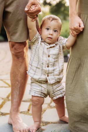 Close-up shots of feet and legs during a casual family photo session outdoors.