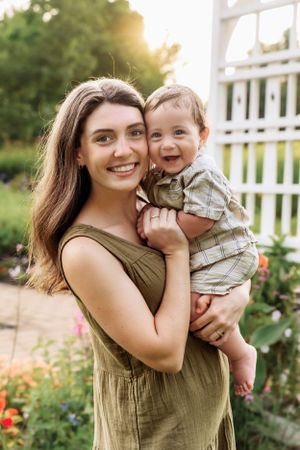 Candid family portraits showing laughter and love in a sunlit garden setting.