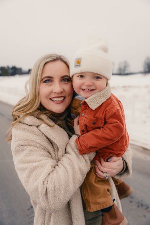 Winter family portraits in the snow with cozy outerwear.