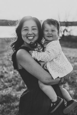 Joyful black and white portraits of mother and child playing outdoors.