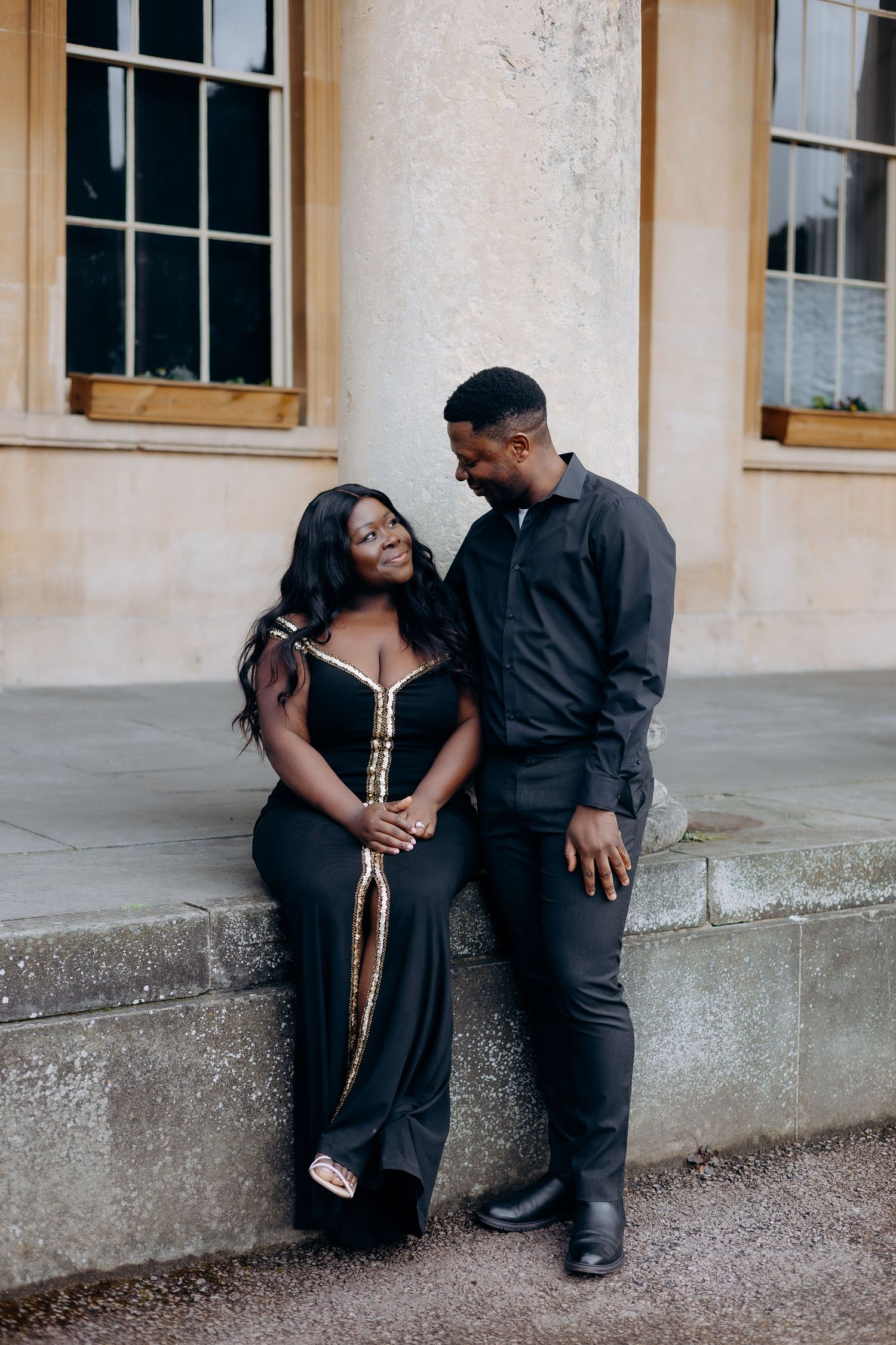 Couple in formal attire posing in front of Cheltenham pump room for their pre wedding photoshoot.