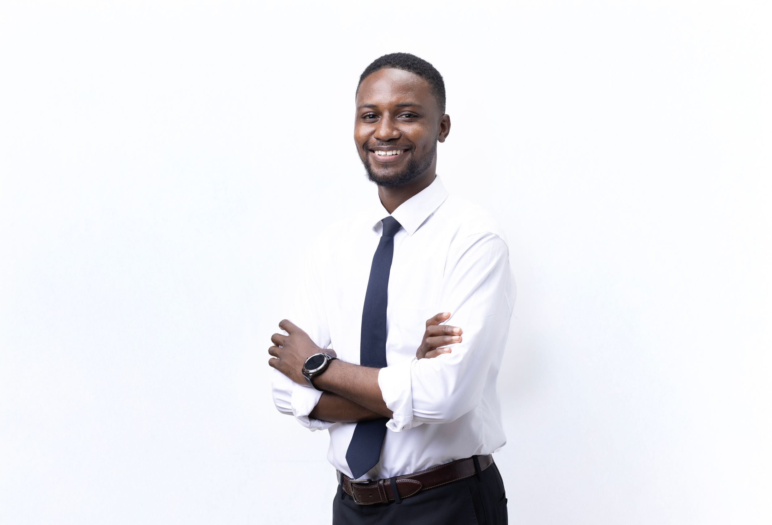 Professional portrait of someone in white shirt and navy tie against white background.