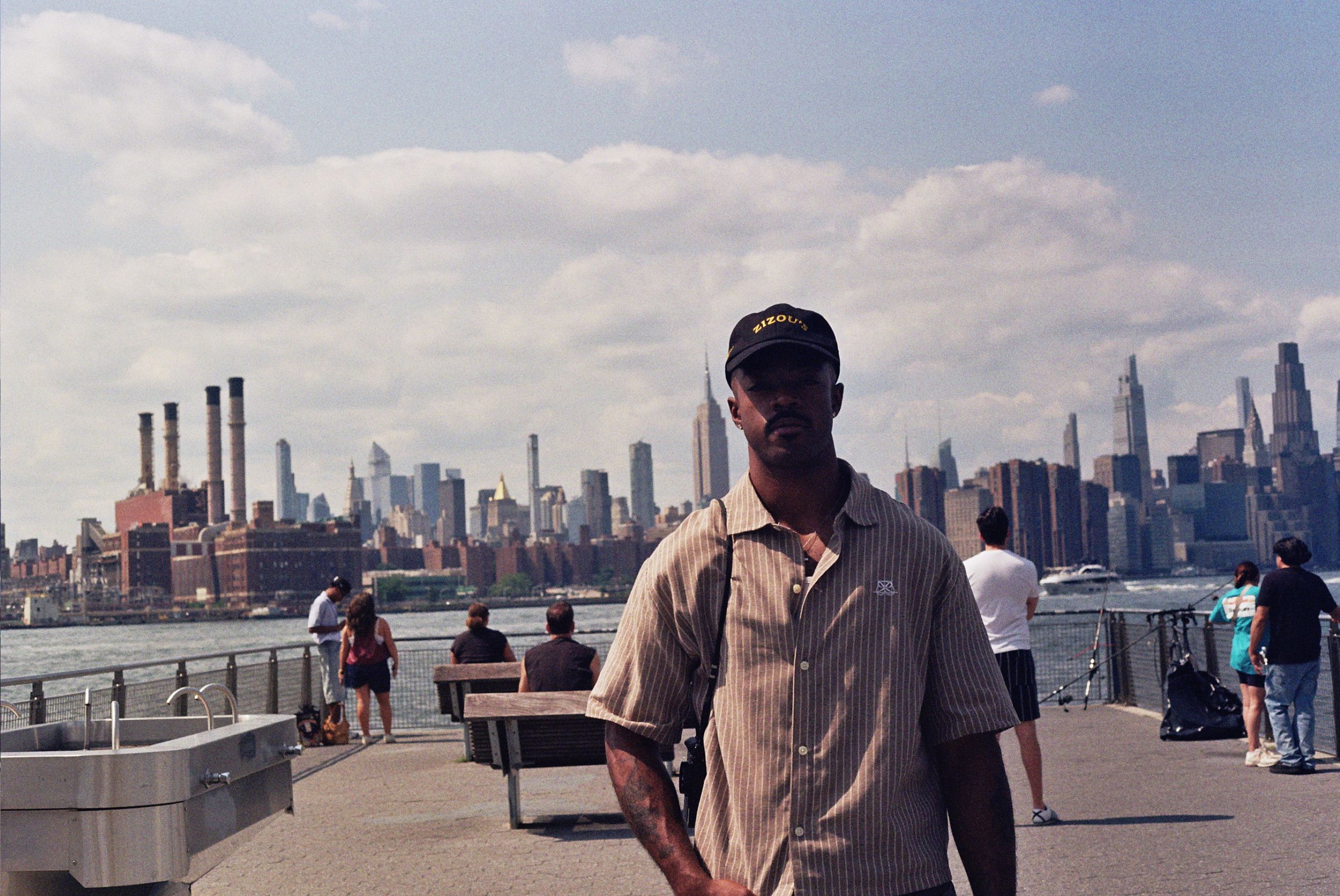 A model poses in front of a New York City skyline