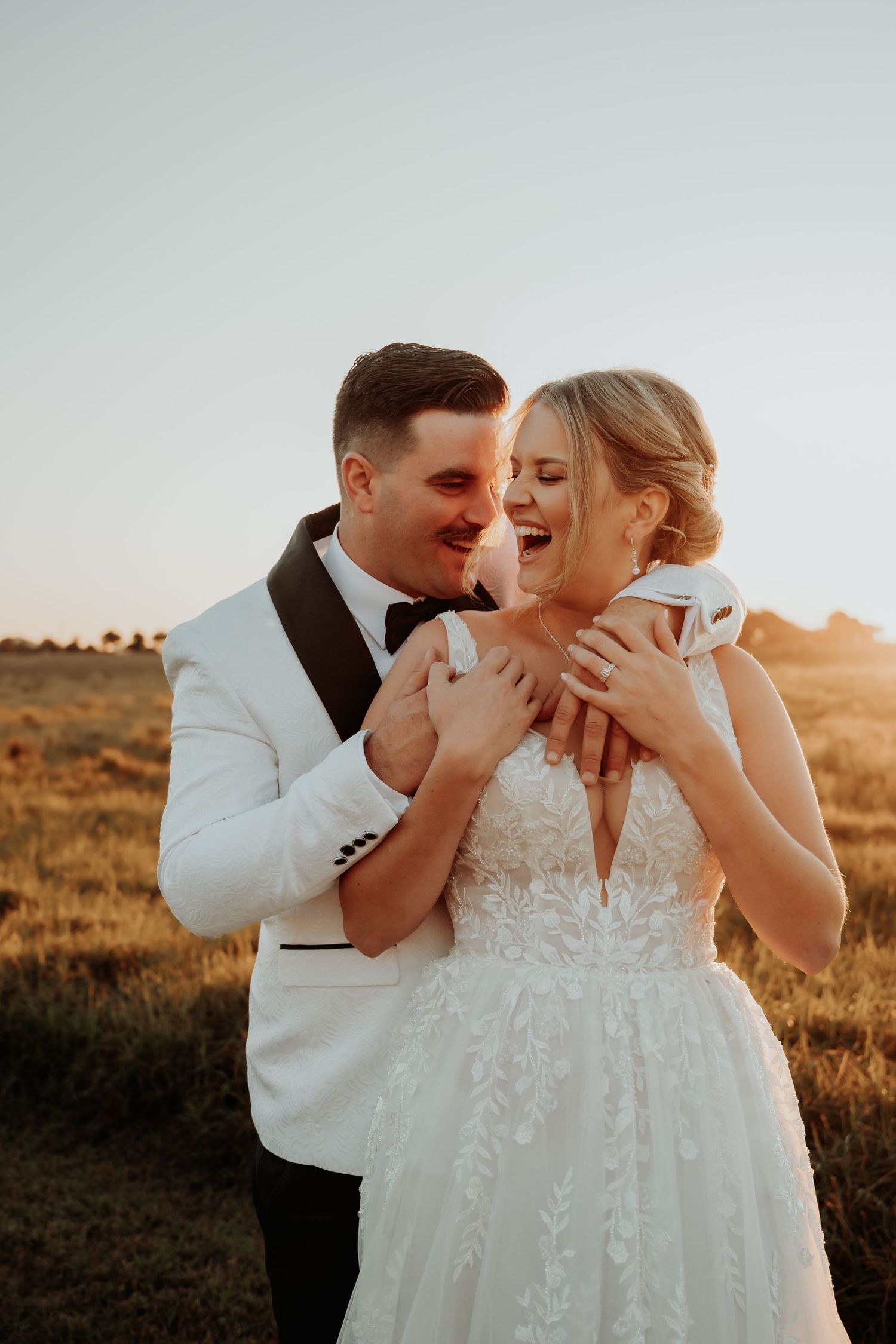 Romantic sunset moment between newlyweds in formal wedding attire at hedlow retreat wedding venue.