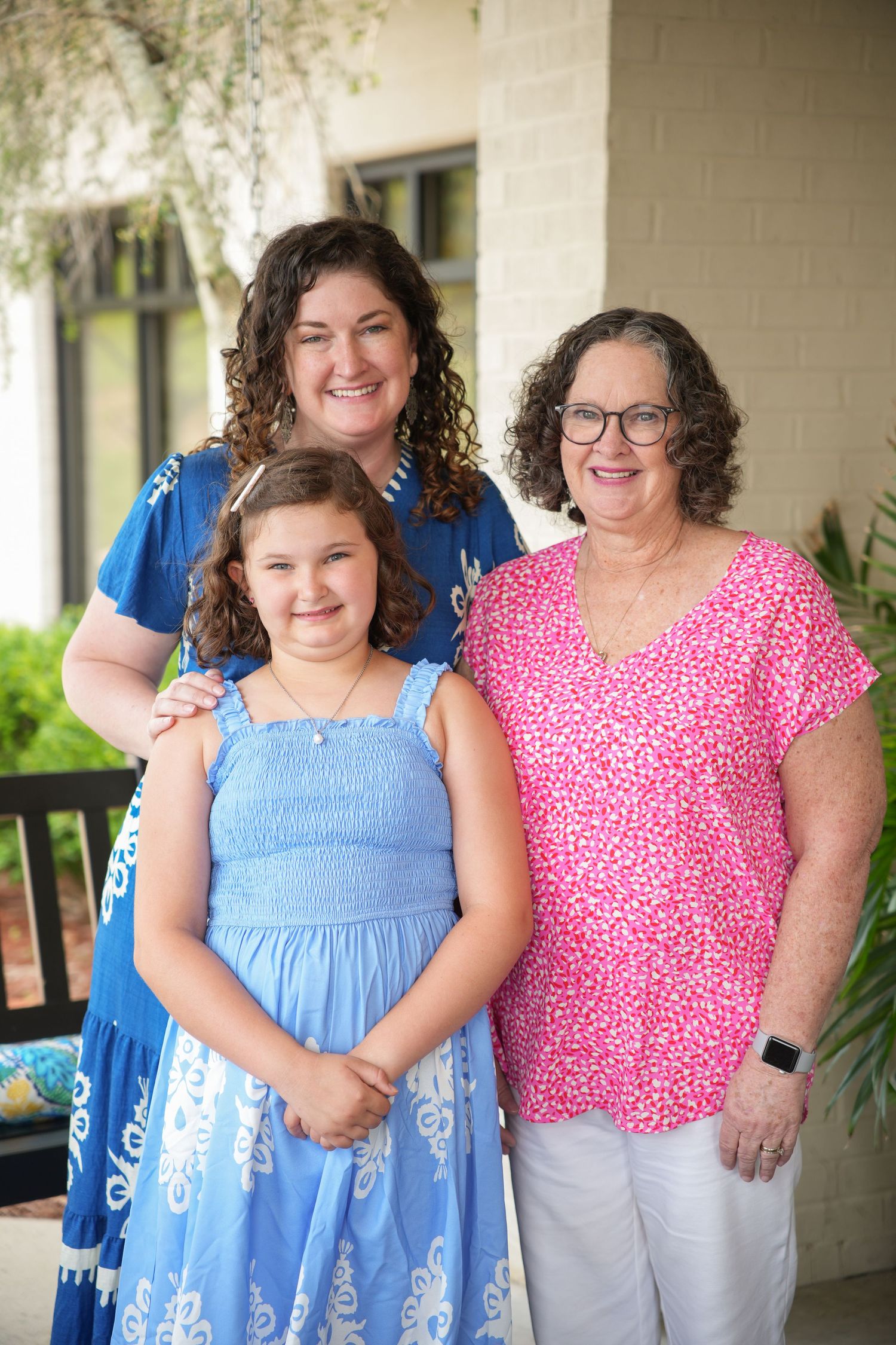 A series of casual family photos showing people in blue and pink outfits on a porch.