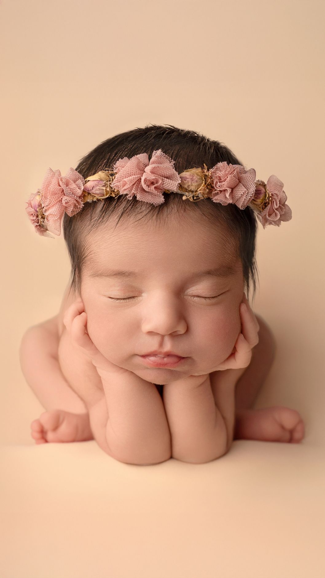 Newborn baby girl in froggy posed safely in West London studio